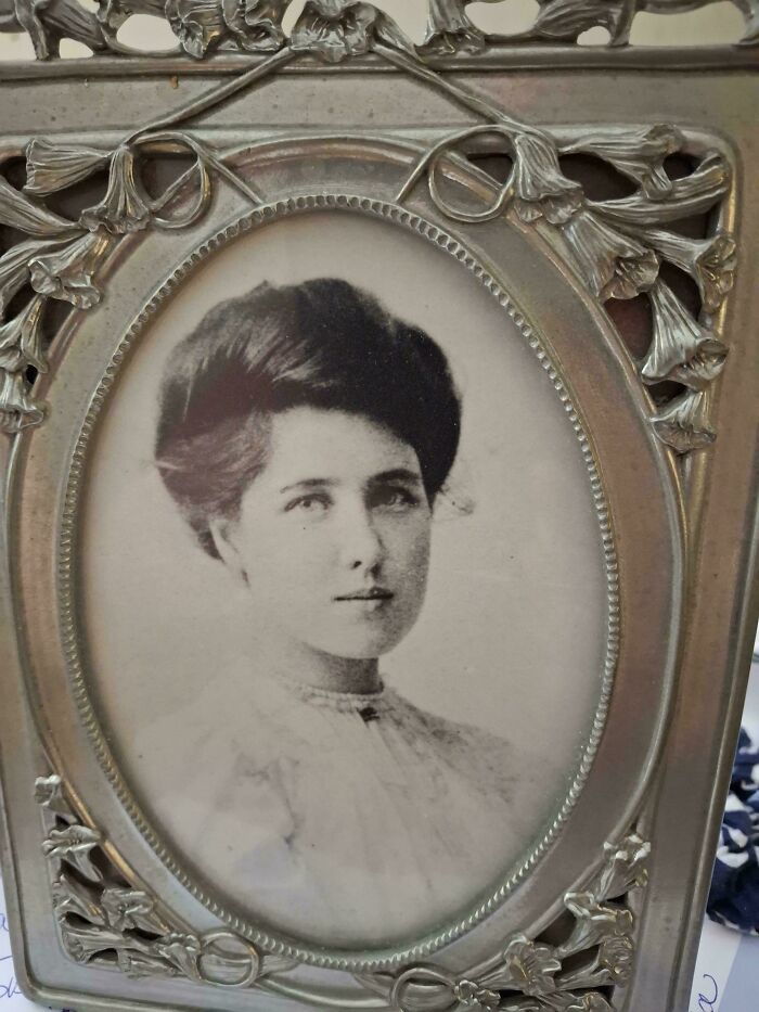 Vintage portrait of a young woman in an ornate frame, showcasing candid glimpses into the past not found in history books.