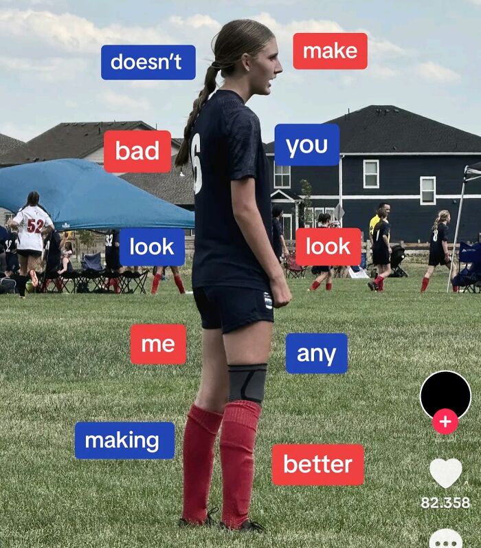 Soccer player stands on field with mismatched word signs, creating unintentional message fail.