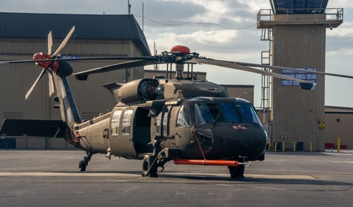 Black Hawk helicopter on tarmac at airfield before DC plane crash with visible control tower in background. Black Hawk helicopter on tarmac at airfield before DC plane crash with visible control tower in background.