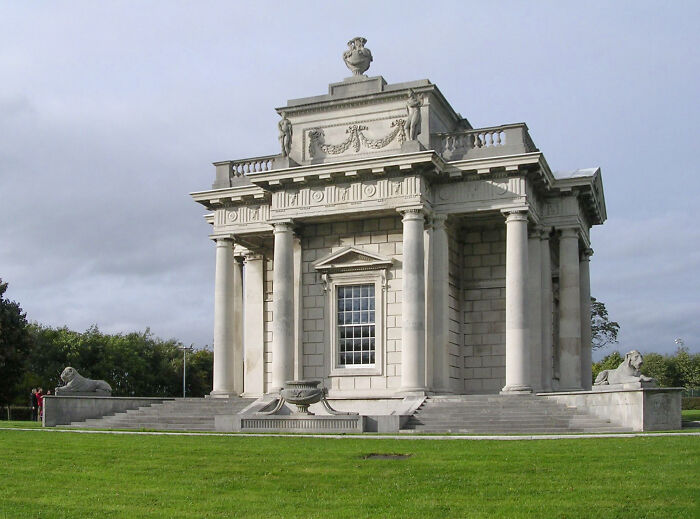 Elegant neoclassical structure with columns and statues, an example of beautiful but useless architecture.