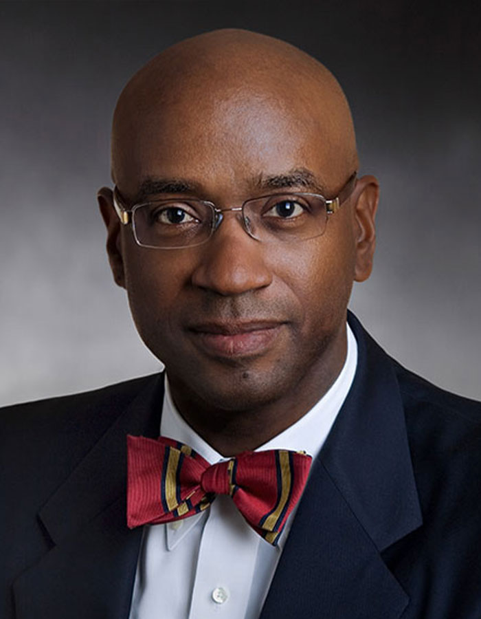 A man wearing glasses and a red bow tie, relevant to Diddy's lawyer in a legal context. A man wearing glasses and a red bow tie, relevant to Diddy's lawyer in a legal context.