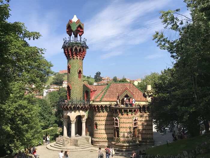 Beautiful but seemingly useless building with intricate design surrounded by greenery under a clear blue sky.
