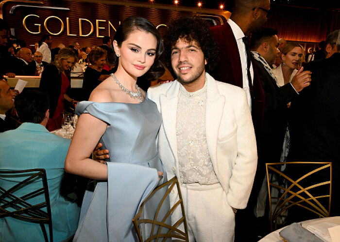 A woman in an elegant blue gown and a man in a white suit at a formal event, sparking conversation among fans. A woman in an elegant blue gown and a man in a white suit at a formal event, sparking conversation among fans.