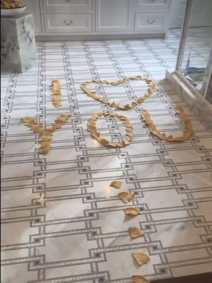 Potato chips arranged on a tiled floor to spell "I love you". Potato chips arranged on a tiled floor to spell "I love you".