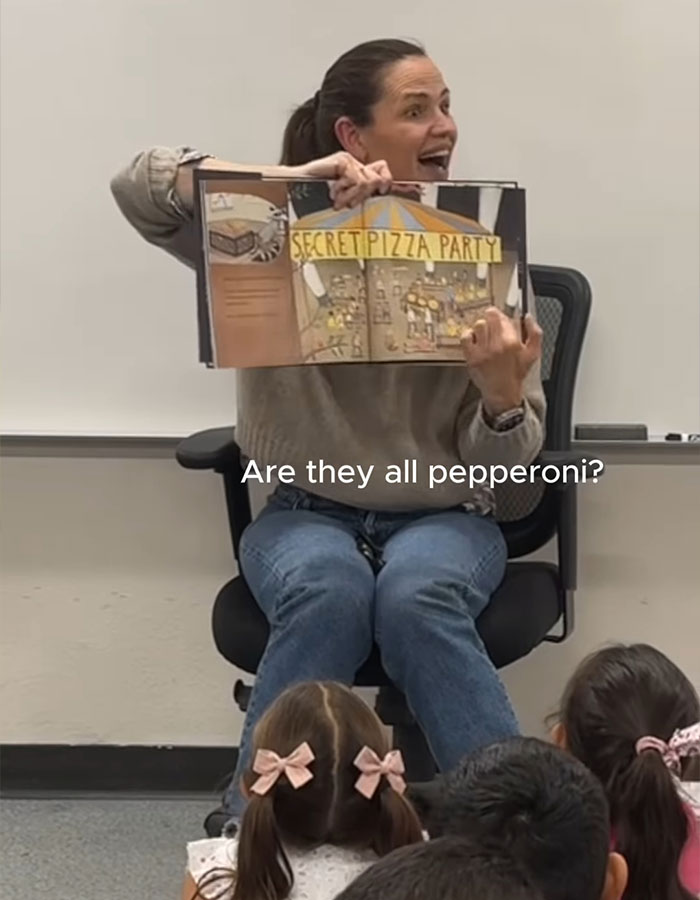 Woman reading "Secret Pizza Party" to children at event, described as "creepy" and investigated by FBI. Woman reading "Secret Pizza Party" to children at event, described as "creepy" and investigated by FBI.