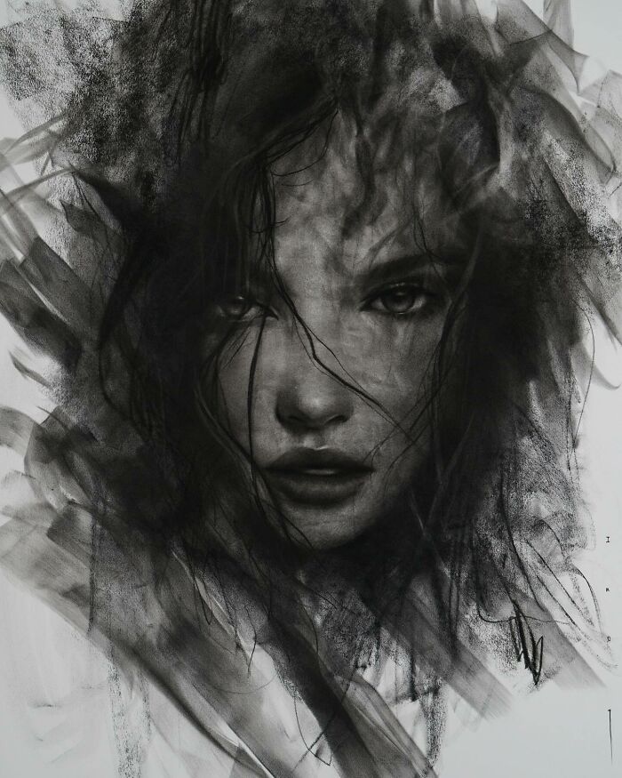Charcoal portrait of a woman's face with intense expression, artwork by Josh Hernandez.