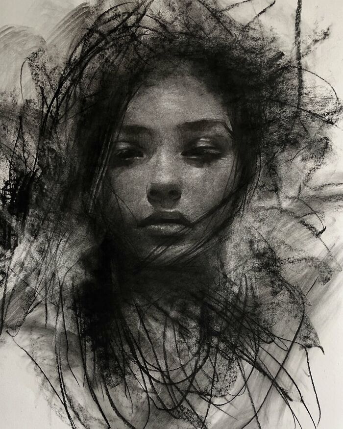 Charcoal portrait of a woman with striking facial features, created by artist Josh Hernandez.