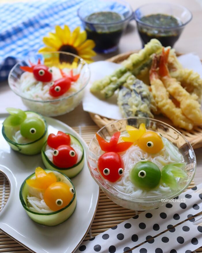 Creative lunchbox ideas featuring noodle bowls with colorful, fish-shaped vegetables by a talented Japanese artist.