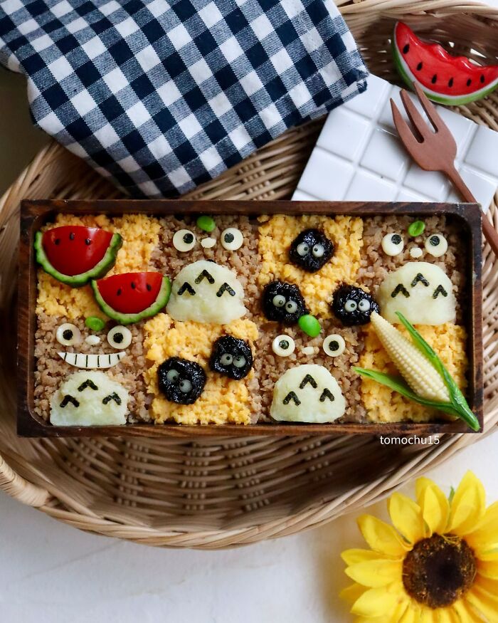 Creative lunchbox with whimsical Totoro-themed food art by a talented Japanese artist.