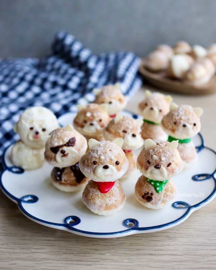 Creative lunchbox ideas featuring cute dog-shaped pastries by a Japanese artist on a decorative plate.