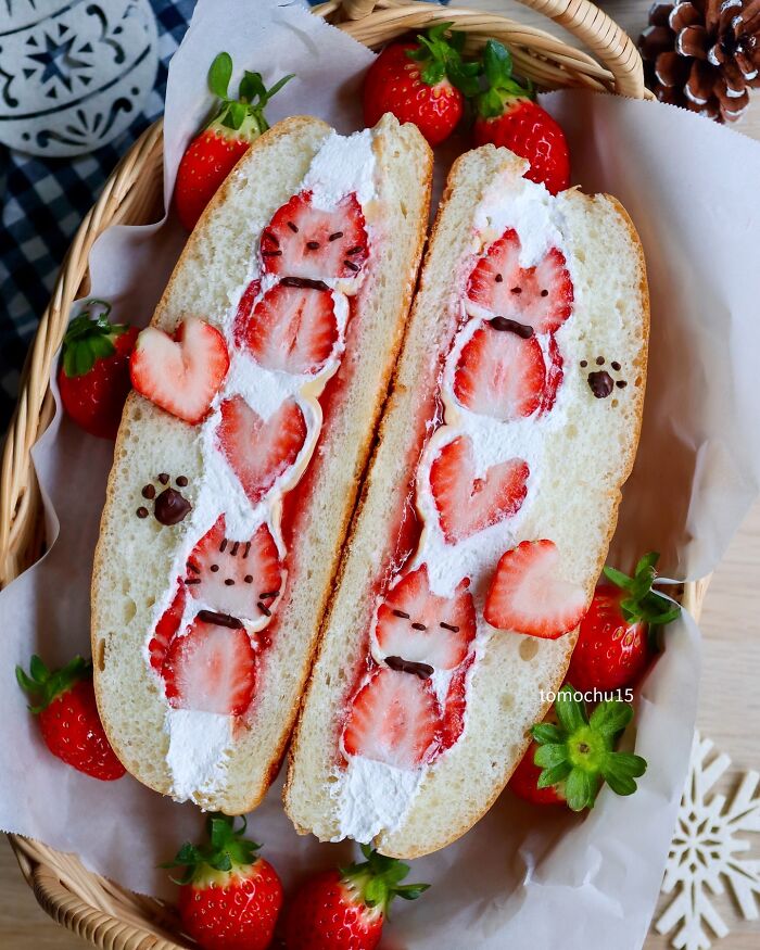 Creative lunchbox idea with strawberry and cream-filled sandwich art shaped like cute animals by a Japanese artist.