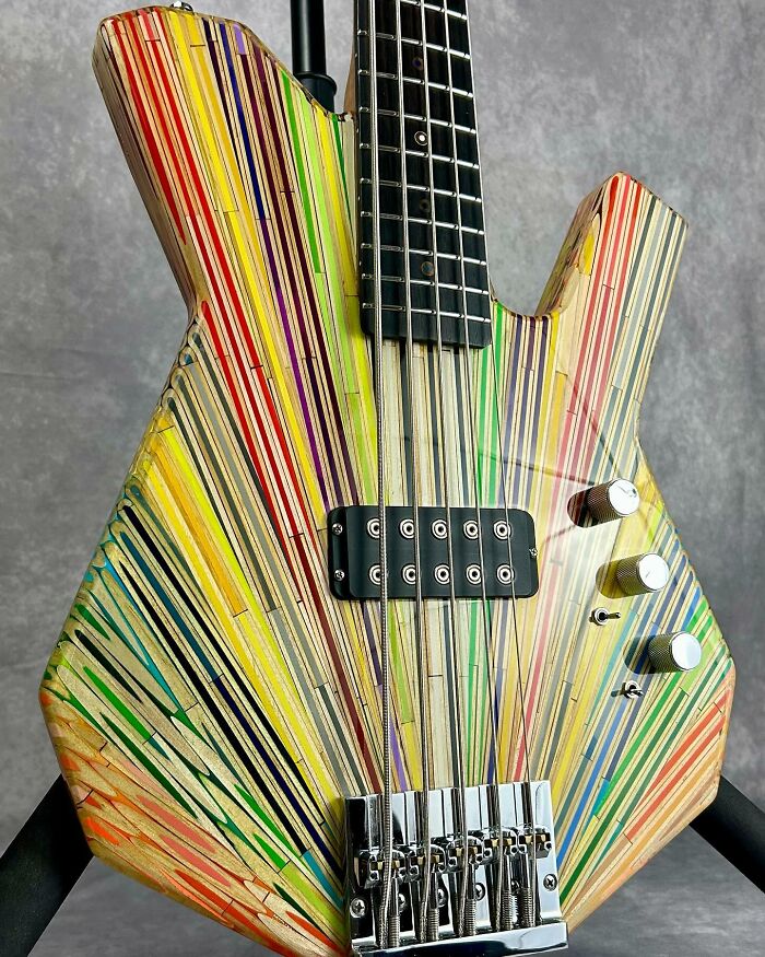 Colorful guitar crafted from unexpected materials, featuring vibrant streaks and unique design.