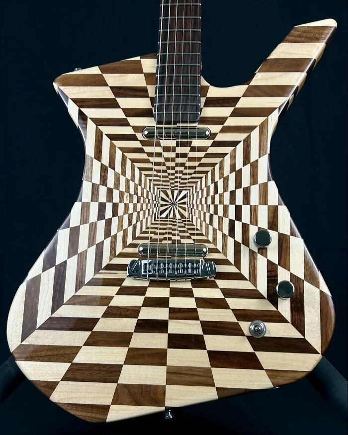 Guitar with a stunning optical illusion pattern, crafted from unexpected materials.