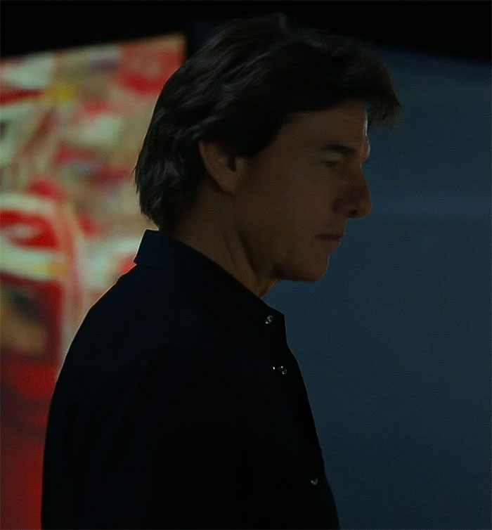 A man in a dark setting, blurred colorful background, capturing intrigue about face appearance. A man in a dark setting, blurred colorful background, capturing intrigue about face appearance.