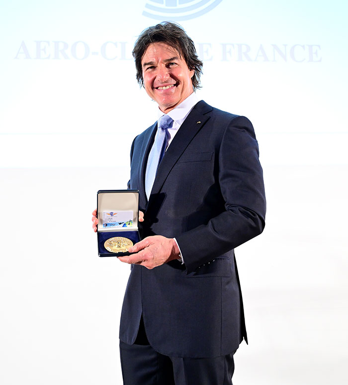 Man in a suit holding an award, smiling at an event, related to discussions about his appearance in Super Bowl 2025. Man in a suit holding an award, smiling at an event, related to discussions about his appearance in Super Bowl 2025.