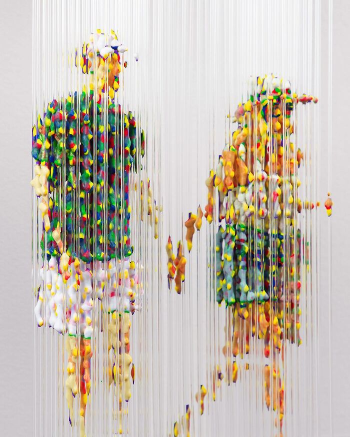 Fragmented three-dimensional painting of people by Chris Dorosz, featuring colorful droplets suspended on vertical strings.
