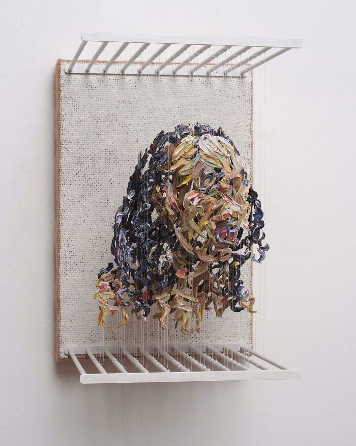Three-dimensional fragmented painting of a person's head on a textured canvas by Chris Dorosz.