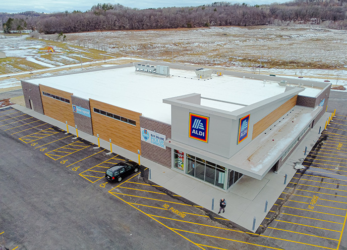 Aerial view of Aldi store with a sign referencing a controversial kids' toy, parking lot visible. Aerial view of Aldi store with a sign referencing a controversial kids' toy, parking lot visible.