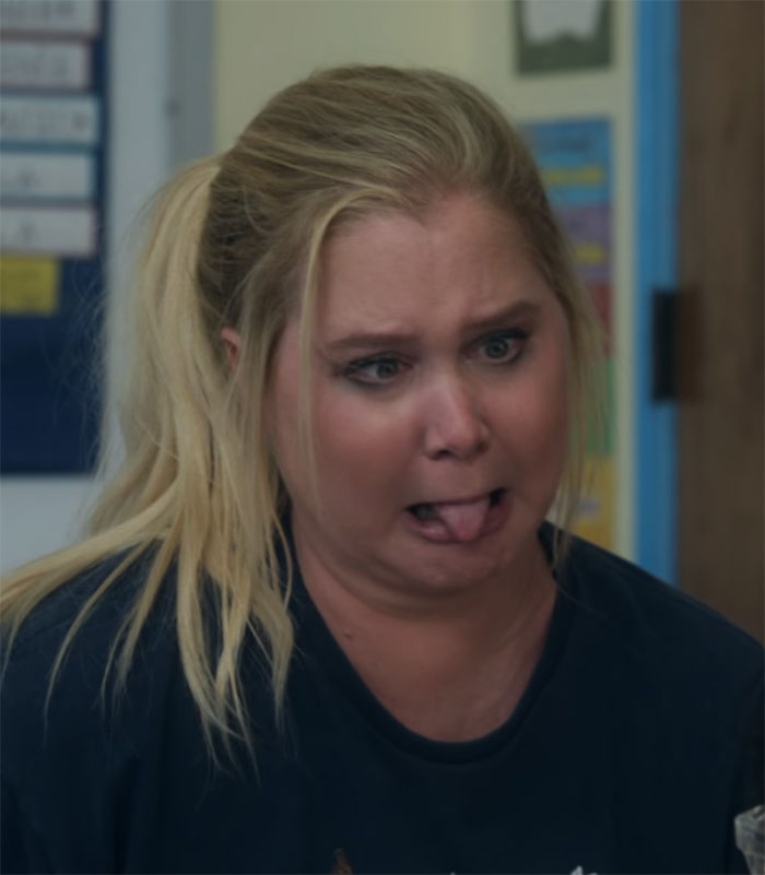 Blonde woman making a funny face, sticking her tongue out, in a comedic setting. Blonde woman making a funny face, sticking her tongue out, in a comedic setting.