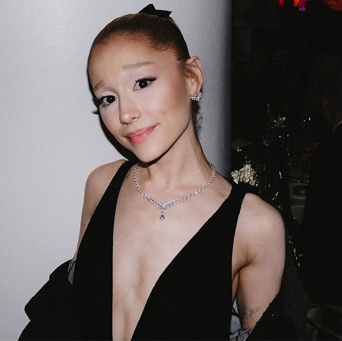 Ariana Grande in a black dress with a diamond necklace poses at an event, sparking concern for her thin appearance. Ariana Grande in a black dress with a diamond necklace poses at an event, sparking concern for her thin appearance.