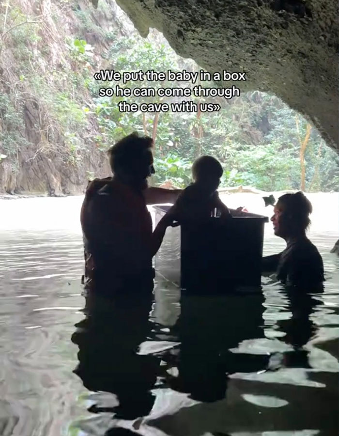 Parents with baby in a plastic box in a cave in Thailand, creating controversy. Parents with baby in a plastic box in a cave in Thailand, creating controversy.