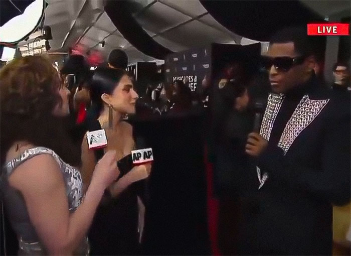 Reporters interviewing a celebrity at Grammys, live event coverage, related to a controversy over "R&B legend" snub. Reporters interviewing a celebrity at Grammys, live event coverage, related to a controversy over "R&B legend" snub.