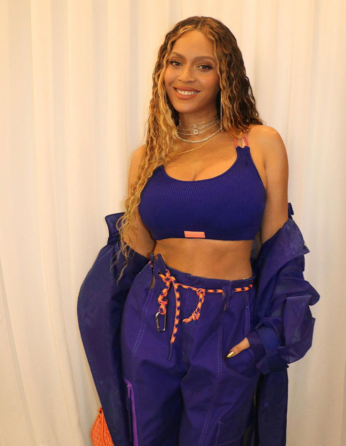 Woman in a blue outfit smiling, related to Blue Ivy’s resemblance to her mom at the Super Bowl. Woman in a blue outfit smiling, related to Blue Ivy’s resemblance to her mom at the Super Bowl.