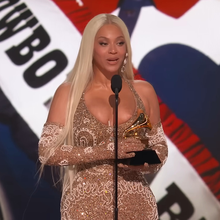 Beyoncé in glittering dress holds Grammy on stage, wardrobe malfunction noted during the event. Beyoncé in glittering dress holds Grammy on stage, wardrobe malfunction noted during the event.