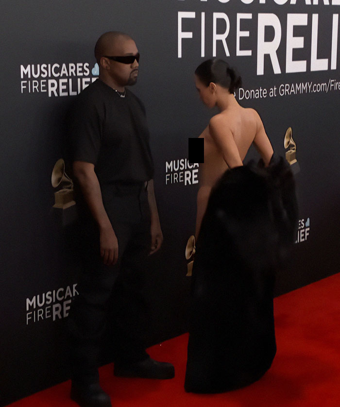 Bianca Censori in revealing outfit at Grammys red carpet with child nearby. Bianca Censori in revealing outfit at Grammys red carpet with child nearby.