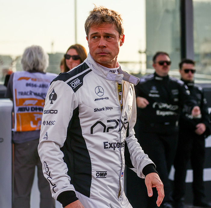 Actor in racing suit at motorsport event, showcasing tattoos. Actor in racing suit at motorsport event, showcasing tattoos.