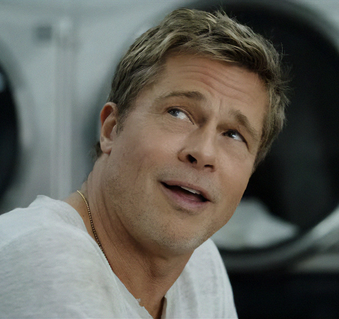 A man in a white shirt smiling, highlighting tattoos honoring someone special. A man in a white shirt smiling, highlighting tattoos honoring someone special.