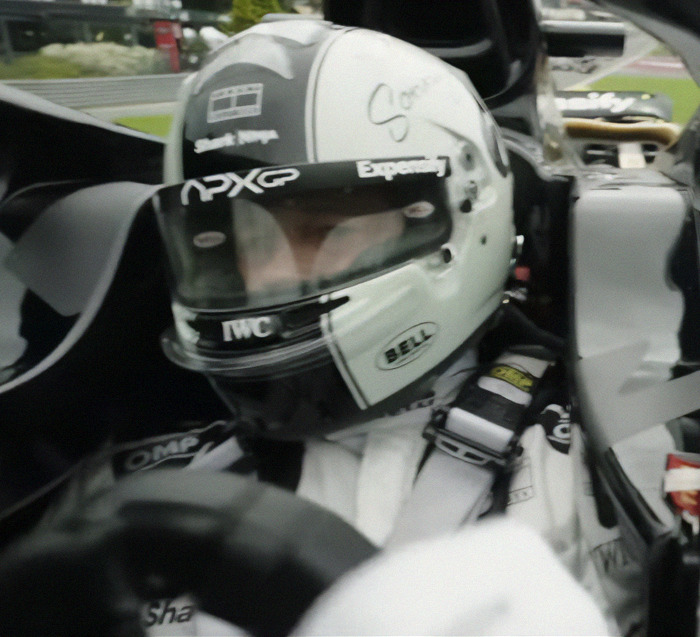 Race car driver in helmet and suit, focused in the cockpit, Brad Pitt tattoos unseen. Race car driver in helmet and suit, focused in the cockpit, Brad Pitt tattoos unseen.