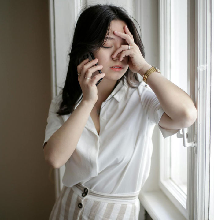 A woman on the phone looking frustrated, possibly discussing wedding refunds. A woman on the phone looking frustrated, possibly discussing wedding refunds.