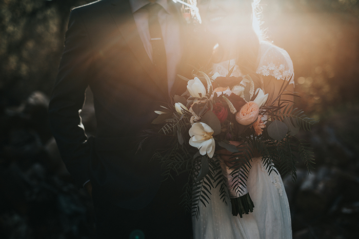 Couple in sunlight, woman holding bouquet, related to wedding and white dress etiquette. Couple in sunlight, woman holding bouquet, related to wedding and white dress etiquette.