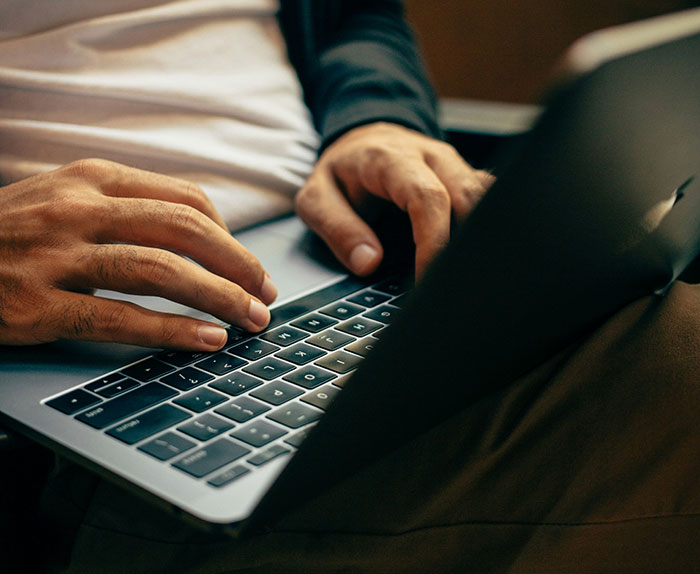 Hands typing on a laptop in an effort to get revenge for unpaid work. Hands typing on a laptop in an effort to get revenge for unpaid work.