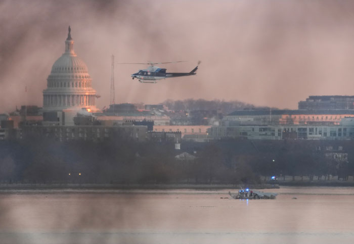 A Black Hawk helicopter flying over DC skyline near the Capitol, with hazy sky, related to a secret drill before a plane crash. A Black Hawk helicopter flying over DC skyline near the Capitol, with hazy sky, related to a secret drill before a plane crash.