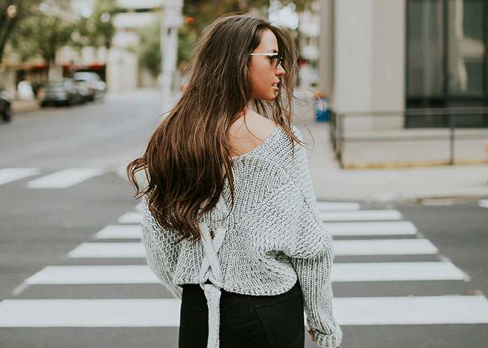 Woman crossing the street, highlighting fashion and lifestyle, related to job probation and punctuality issues. Woman crossing the street, highlighting fashion and lifestyle, related to job probation and punctuality issues.