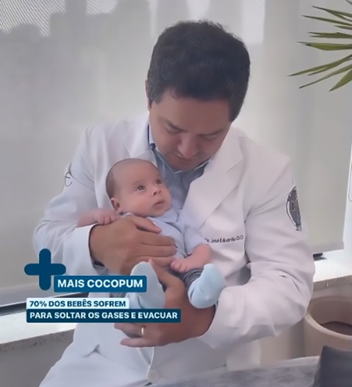 Doctor demonstrating viral baby farting tips with an infant in his arms, sparking online reactions. Doctor demonstrating viral baby farting tips with an infant in his arms, sparking online reactions.