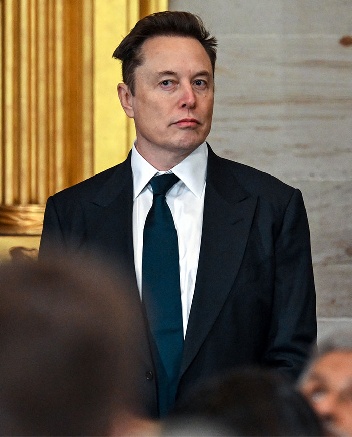 Elon Musk wearing a black jacket at a public event. Elon Musk wearing a black jacket at a public event.