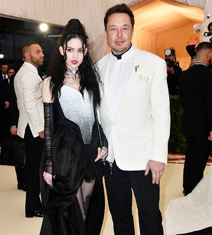 A couple in formal attire, posing at an event, related to Grimes and Elon Musk news. A couple in formal attire, posing at an event, related to Grimes and Elon Musk news.