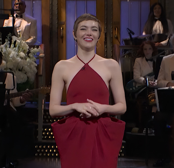Emma Stone in a popcorn dress on stage during an SNL performance. Emma Stone in a popcorn dress on stage during an SNL performance.