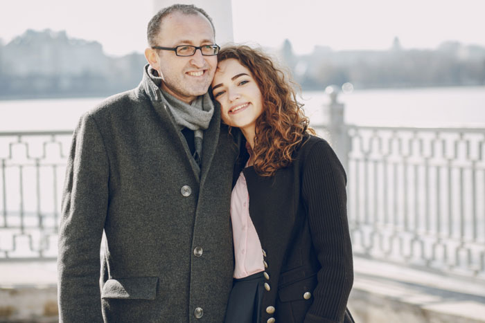 Father and daughter smiling outdoors, related to road trip and anxious feelings. Father and daughter smiling outdoors, related to road trip and anxious feelings.