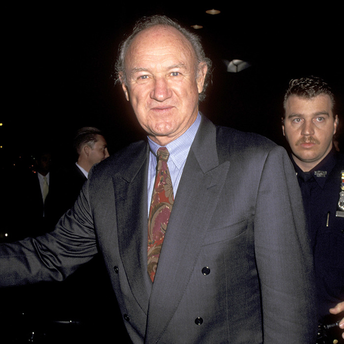 Gene Hackman in a suit at an event with security behind. Gene Hackman in a suit at an event with security behind.