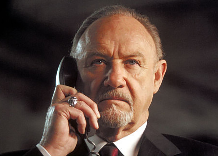 Gene Hackman holding a phone in a movie scene. Gene Hackman holding a phone in a movie scene.