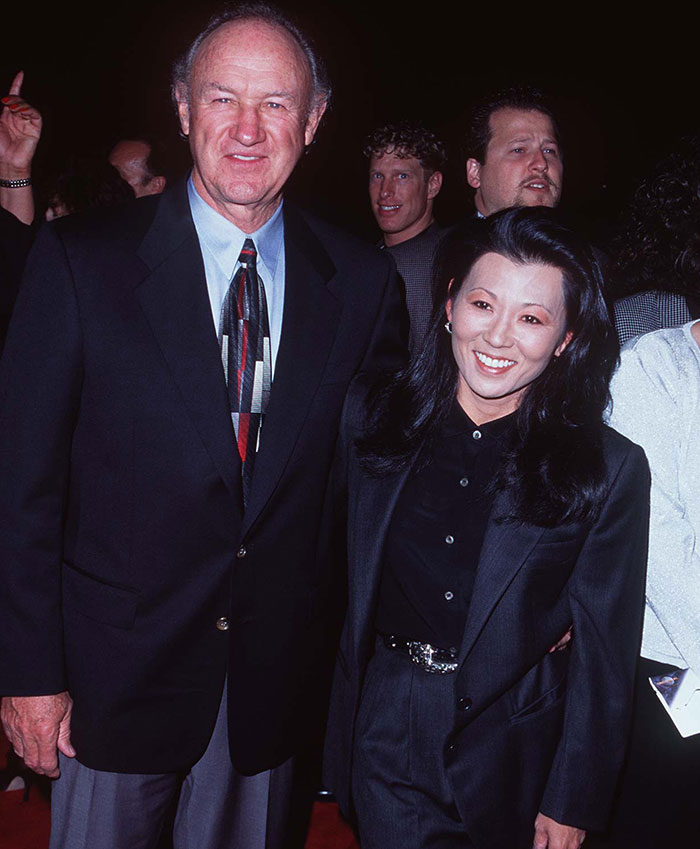 Elderly couple smiling together at an event, both dressed in formal attire. Elderly couple smiling together at an event, both dressed in formal attire.