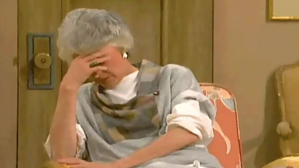 Elderly woman facepalming on a chair, expressing disbelief in a hilariously random post catching attention online.