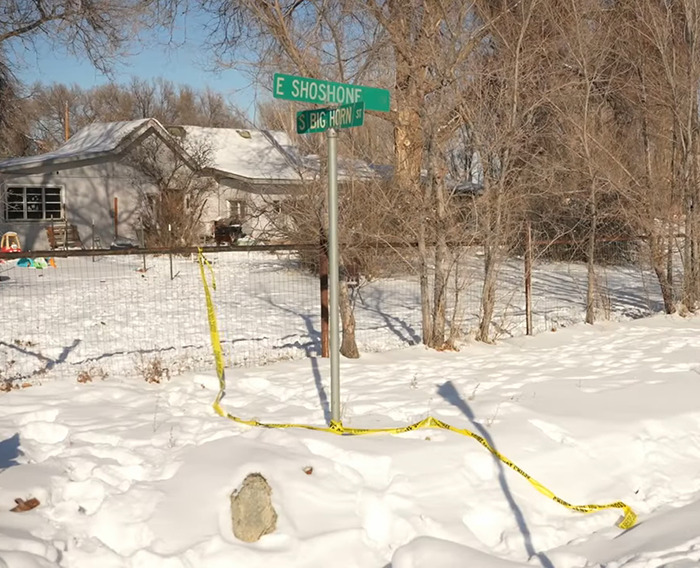 Snow-covered crime scene near house with street signs at East Shoshone and South Big Horn. Snow-covered crime scene near house with street signs at East Shoshone and South Big Horn.