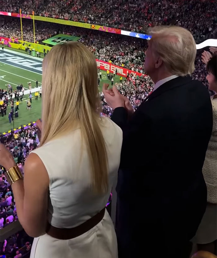 Spectators at a Super Bowl event, with focus on hair extensions style from behind. Spectators at a Super Bowl event, with focus on hair extensions style from behind.