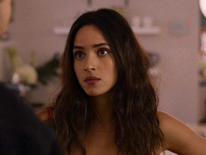 Young woman with long hair, indoors, associated with Jason Momoa on red carpet. Young woman with long hair, indoors, associated with Jason Momoa on red carpet.