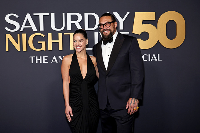 Jason Momoa and guest in formal attire at a red carpet event, posing together. Jason Momoa and guest in formal attire at a red carpet event, posing together.